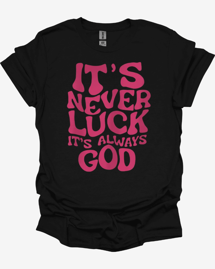 Black It’s Never Luck It’s Always God Faith Graphic Tee with pink text 'It's never luck, it's always God' on a white background