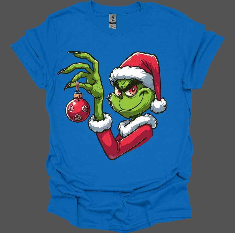 Blue Christmas With the Grinch Tee with a graphic of a character holding a Christmas ornament on a transparent background
