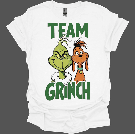 White t-shirt with 'Team Grinch' graphic featuring the Grinch and a dog on a dark gray background.