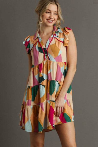 model wearing a button detail ruffle sleeve mini dress, standing confidently